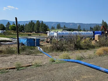 Vacuum tanker and transfer hose at a lagoon cleanout