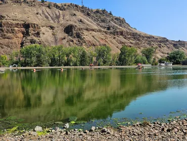 Calm reservoir beneath rocky bluffs